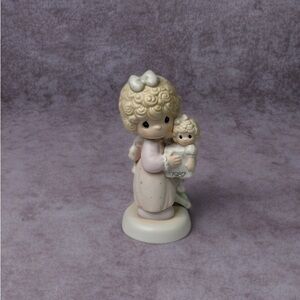Precious Moments "Love Is The Best Gift Of All" figurine from 1987.